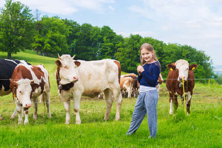 Cute little girl resting on a farm in summertimeの写真素材
