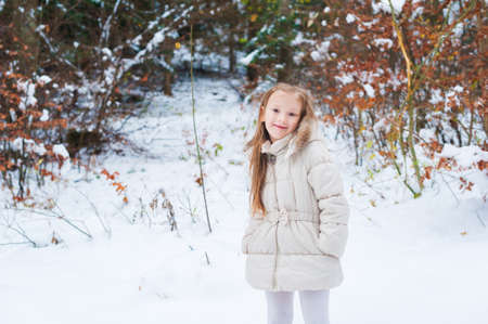 Winter portrait of a cute little girl