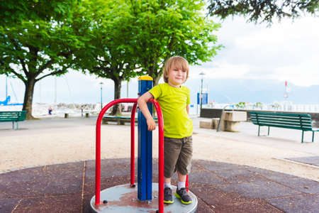 Adorable little by having fun on playgroundの写真素材