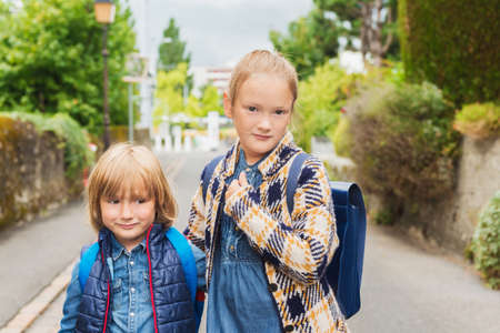 Cute kids with backpacks walking to schoolの写真素材