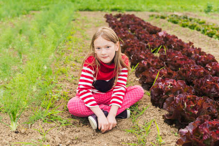 Cute little girl playing in a gardenの写真素材