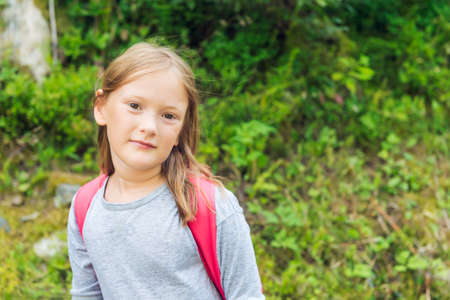Close up portrait of a cute little girl hiking in a forestの写真素材