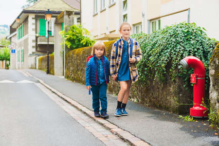 Cute kids with backpacks walking to schoolの写真素材
