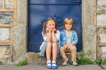 Outdoor portrait of a little girl and her brotherの写真素材