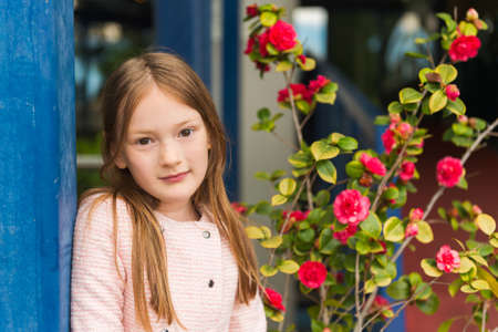 Outdoor portrait of a cute little girl of 7 years oldの写真素材