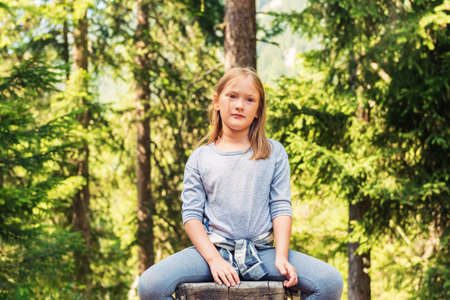 Close up portrait of a cute little girl hiking in a forestの写真素材