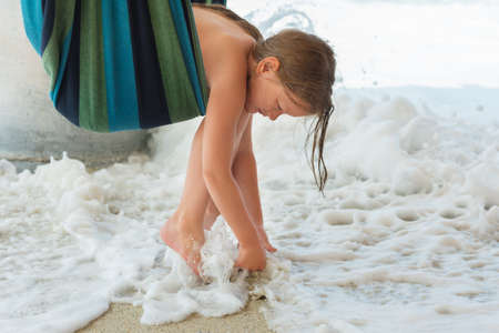 Adorable little girl resting in a hammock on the beachの写真素材