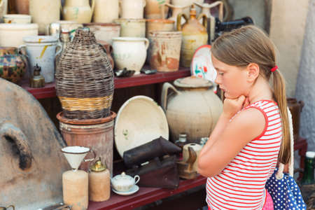 Cute little girl at flea marketの写真素材