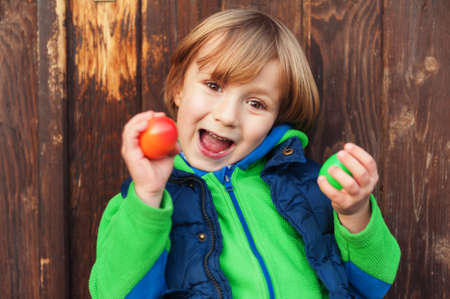 Cute little boy playing with easter eggs, egg hunting