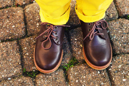 Fashion brown shoes on kid's feetの写真素材