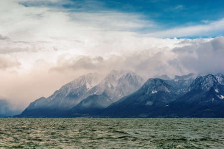French Alps and lake Geneva or Leman on cloudy day