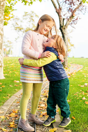 Two adorable kids playing in the park on a nice autumn dayの写真素材