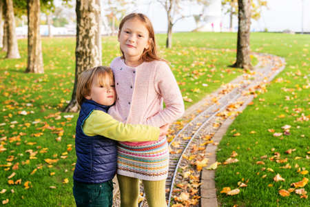 Two adorable kids playing in the park on a nice autumn dayの写真素材