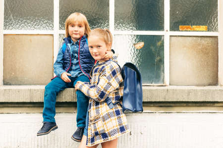 Cute kids with backpacks walking to schoolの写真素材