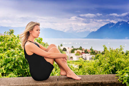 Portrait of young blond woman resting outdoors in Lavaux vineyards, Switzerlandの写真素材