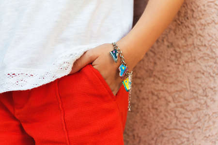Close up of fashion bracelet on kid's armの写真素材