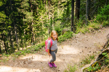 Little hiker girl in forest. Photo from Champex-Lac, Valais, swiss Alps, top viewの写真素材