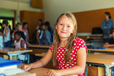 Indoor portrait of a cute little girl in a classroom