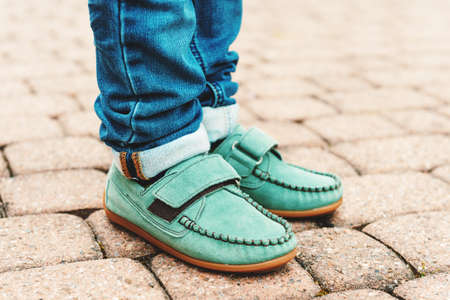 Close up of green moccasins on child's feetの写真素材