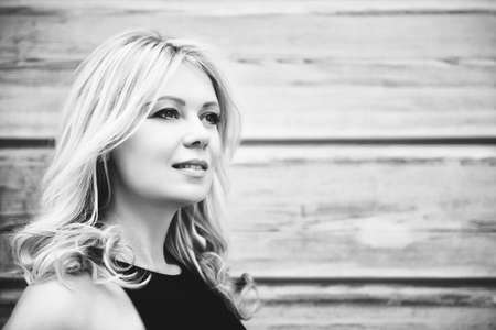 Close up portrait of young blond woman, black and white imageの写真素材