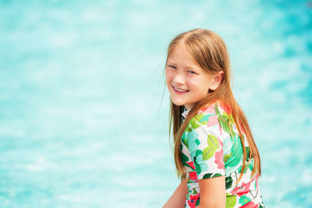 Little girl having fun in the pool on a nice summer dayの写真素材