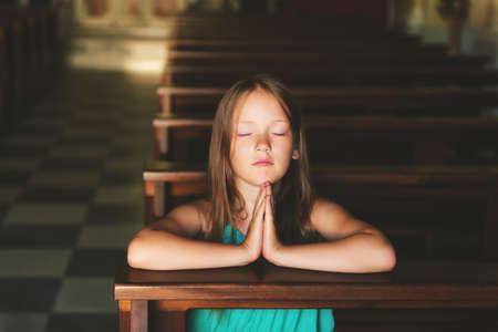 Child praying in church