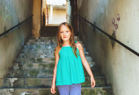 Close up portrait of a cute little girl of 7-8 years old, wearing green topの写真素材