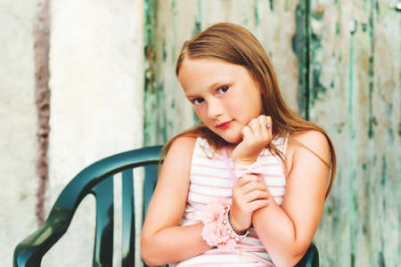 Portrait of a cute little 7-8 year old girl wearing many accessoriesの写真素材
