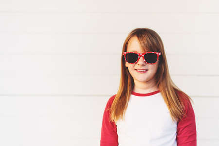 Funny kid girl wearing swiss sunglassesの写真素材