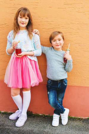 Outdoor portrait of two funny fashion kidsの写真素材