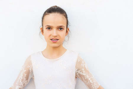 Preteen girl with teeth braces wearing beautiful dressの写真素材