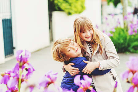 Two funny and happy kids playing together outdoorsの写真素材