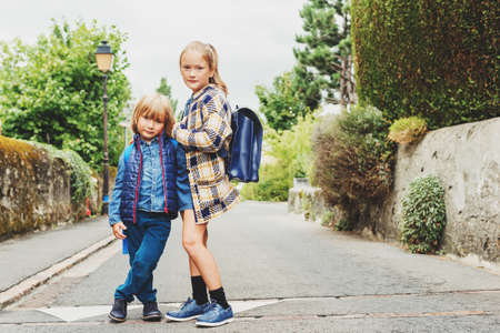 Cute kids with backpacks walking to schoolの写真素材