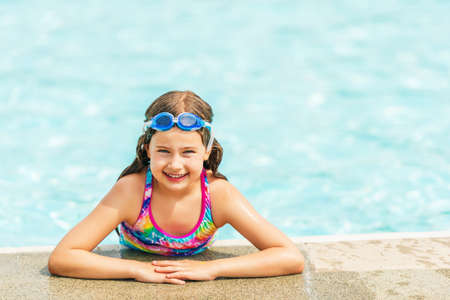Little girl having fun in the pool on a nice summer dayの写真素材