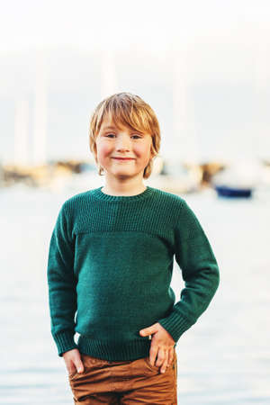Fashion vertical portrait of adorable kid boy wearing green pulloverの写真素材