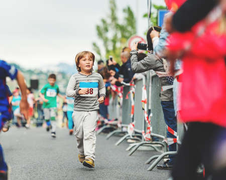 Handsome little 6 year old boy participating in 2 km marathon for childrenの写真素材