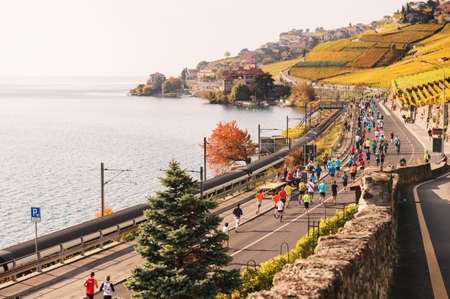 Lausanne area, Canton of Vaud, Switzerland- October 30, 2016: Runners in the Lausanne Marathon going through Lavaux vineyards on swiss frech rivieraのeditorial素材