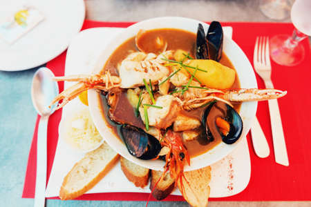 Dish of Bouillabaisse with rouille croutes served at the restaurantの写真素材