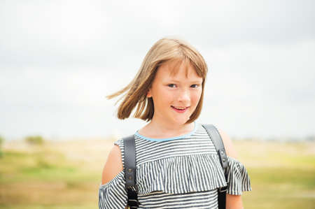 Outdoor summer portrait of sweet little girl with bob haircutの写真素材