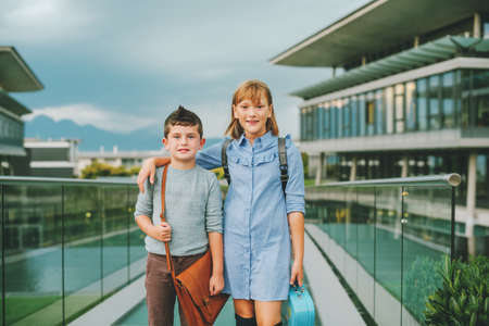Cute kids with backpacks walking back to school