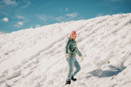 Little girl climbing the snow hill, winter vacation with children. Image taken in Valais, Switzerlandの写真素材
