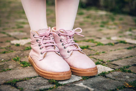 Fashion pink shoes on kid's feetの写真素材