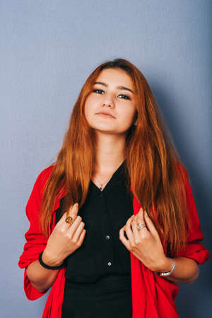 Close up portrait of young girl with red hair taken on purple backgroundの写真素材