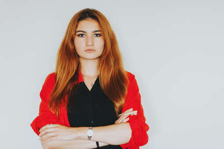 Portrait of young girl with red hair taken on white background