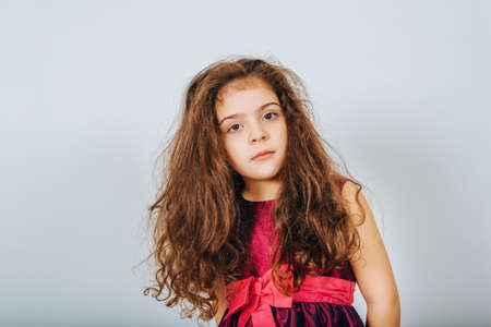Studio shot of 5 year old kid girl with long curly hairの写真素材