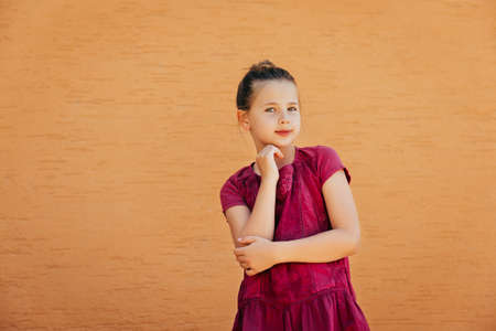 Outdoor portrait of adorable preteen girl wearing pink summer dressの写真素材