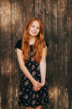 Outdoor fashion portrait of happy red-haired girlの写真素材