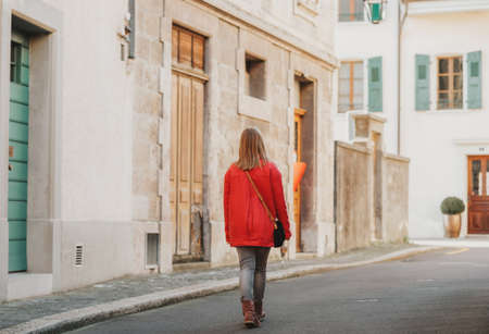 Outdoor portrait of cute teen girl wering red coat, fashion for childrenの写真素材