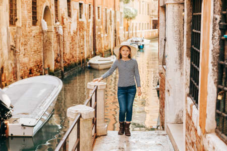 Little girl playing on the streets of Venice. Family travel with childrenの写真素材