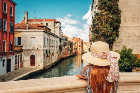 Little girl playing on the streets of Venice. Family travel with childrenの写真素材